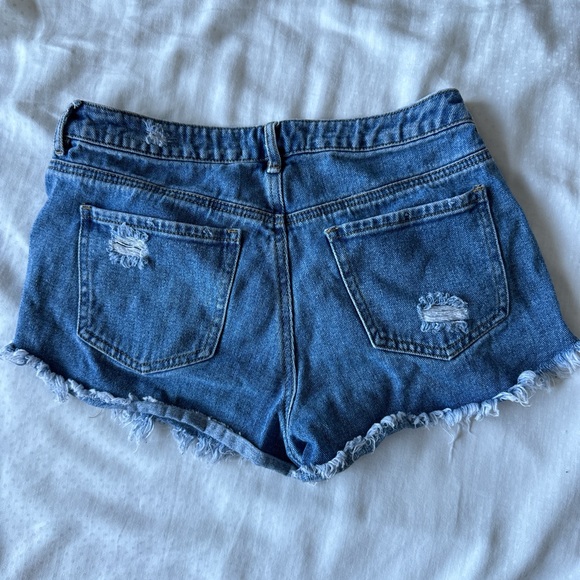 high rise blue festival denim shorts with rips - Picture 2 of 3